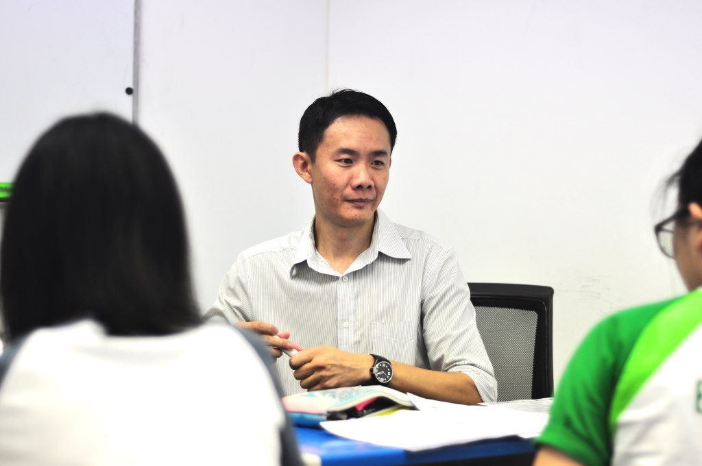 Mr Lau coaching students